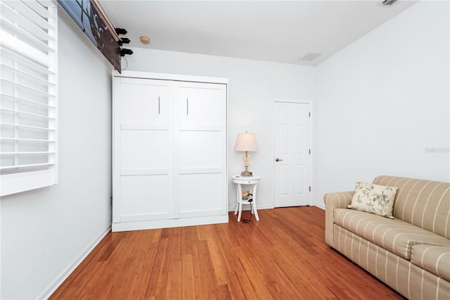 living room with baseboards and wood finished floors