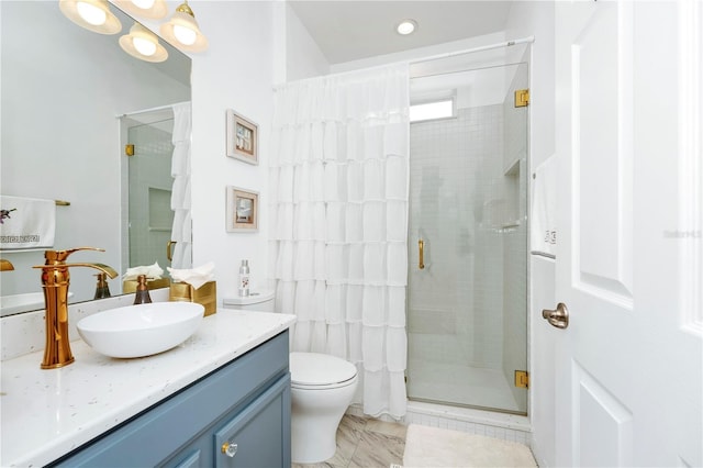 full bath featuring toilet, a stall shower, and vanity