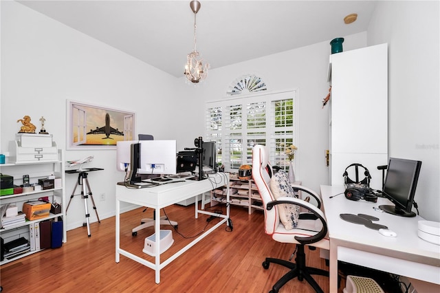 office area with a chandelier and wood finished floors