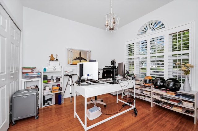office area featuring a chandelier and wood finished floors