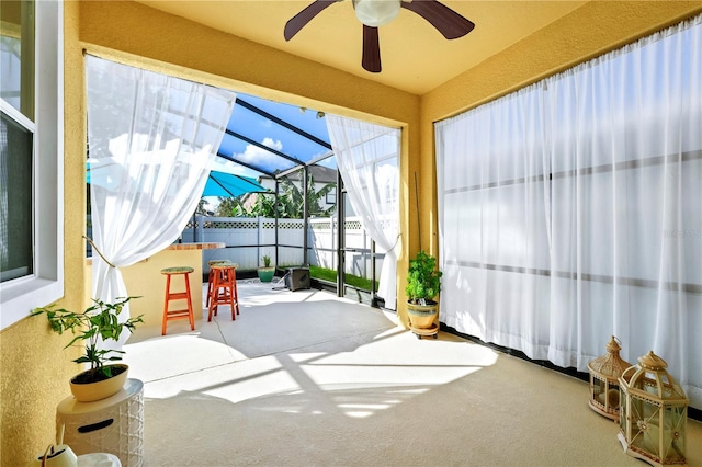 sunroom featuring ceiling fan