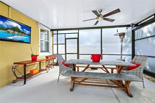 sunroom / solarium with a textured wall and finished concrete flooring