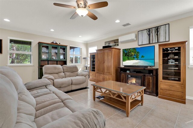 living area featuring light tile patterned floors, visible vents, a ceiling fan, a wall mounted AC, and ornamental molding