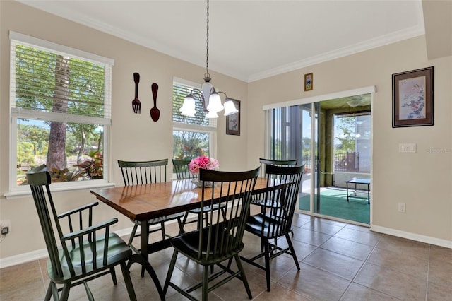 dining room featuring baseboards, crown molding, and tile patterned flooring