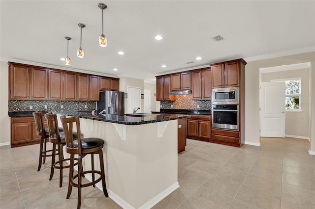 kitchen with under cabinet range hood, visible vents, crown molding, decorative backsplash, and appliances with stainless steel finishes