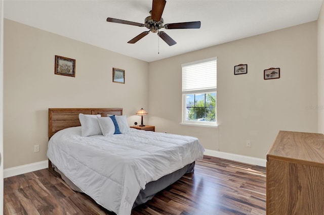 bedroom featuring baseboards, wood finished floors, and ceiling fan