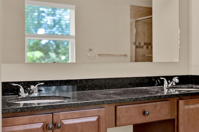 bathroom with an enclosed shower and vanity