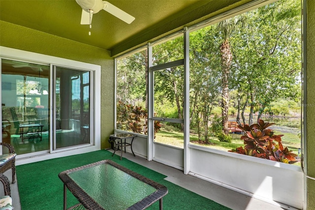 sunroom / solarium featuring ceiling fan