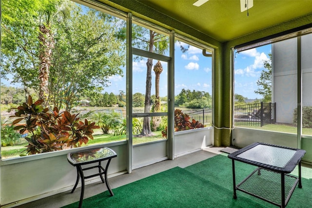 unfurnished sunroom featuring ceiling fan