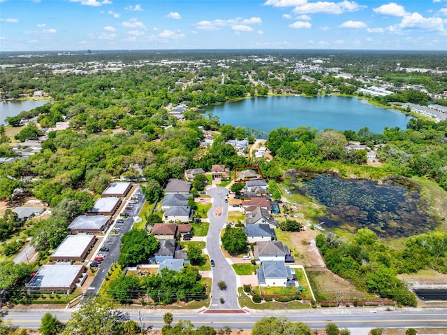 drone / aerial view featuring a residential view and a water view