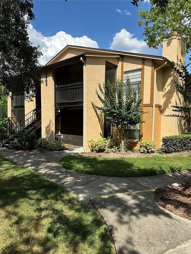 4800 S Semoran Blvd Unit 101, Orlando, FL 32822 - view of front of home with stairway and stucco siding