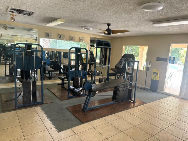4800 S Semoran Blvd Unit 101, Orlando, FL 32822 - exercise room featuring baseboards, tile patterned flooring, carpet flooring, visible vents, and ceiling fan