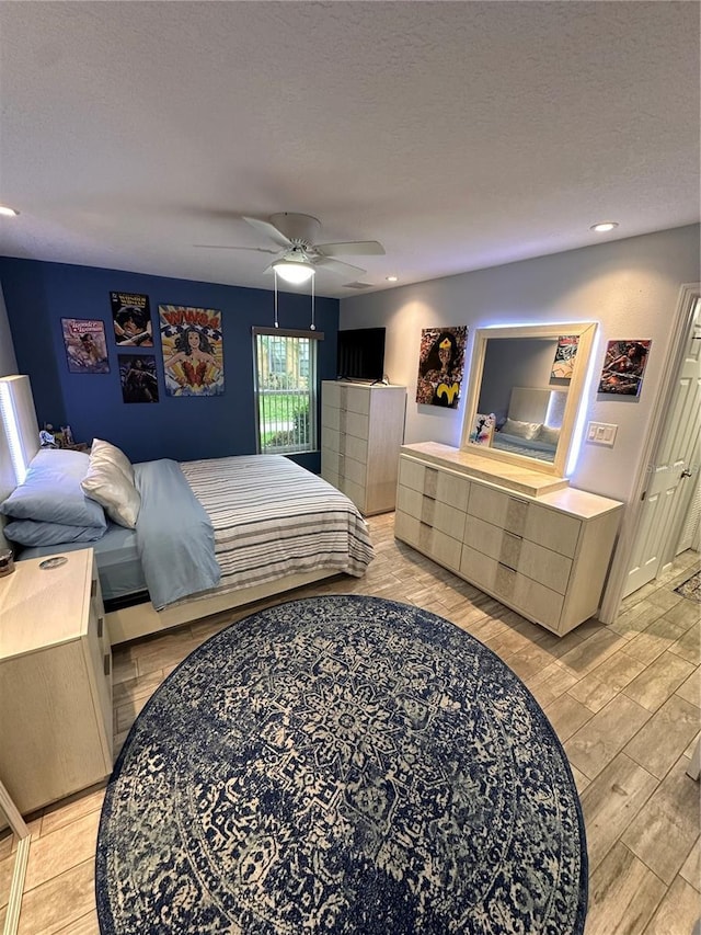 4800 S Semoran Blvd Unit 101, Orlando, FL 32822 - bedroom featuring light wood-type flooring, ceiling fan, recessed lighting, and a textured ceiling