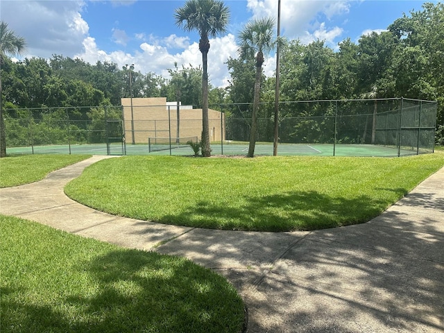 4800 S Semoran Blvd Unit 101, Orlando, FL 32822 - view of property's community featuring a tennis court, a yard, and fence
