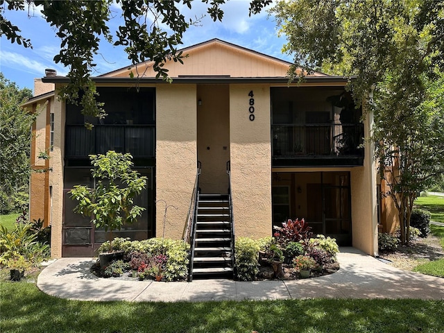 4800 S Semoran Blvd Unit 101, Orlando, FL 32822 - view of front facade featuring stucco siding and stairway