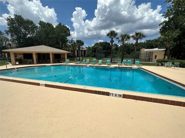 4800 S Semoran Blvd Unit 101, Orlando, FL 32822 - community pool featuring a patio and view of scattered trees