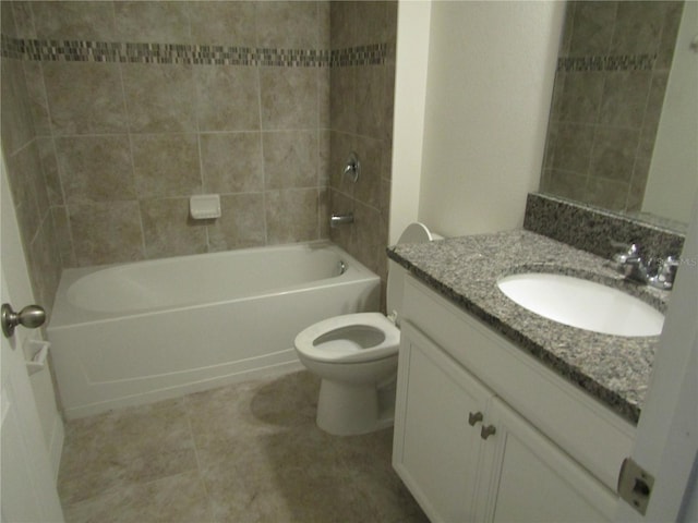 bathroom with tile patterned floors, vanity,  shower combination, and toilet