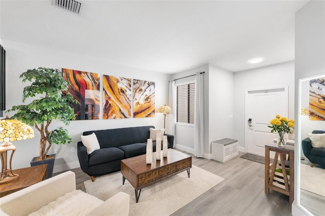 549 NE 206th Ln, Miami, FL 33179 - living area featuring baseboards, visible vents, and light wood-style flooring