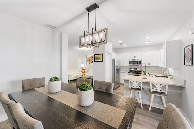 549 NE 206th Ln, Miami, FL 33179 - dining room featuring visible vents, light wood finished floors, and a notable chandelier