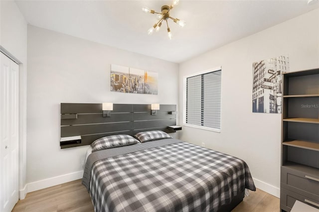 549 NE 206th Ln, Miami, FL 33179 - bedroom with wood finished floors, baseboards, and a chandelier