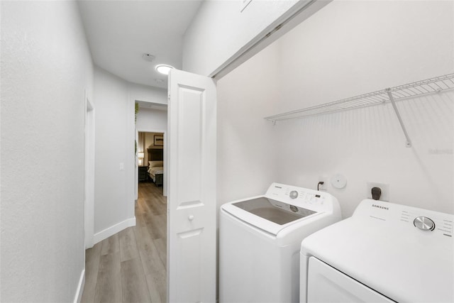 549 NE 206th Ln, Miami, FL 33179 - laundry room with washing machine and dryer, baseboards, laundry area, and light wood-type flooring