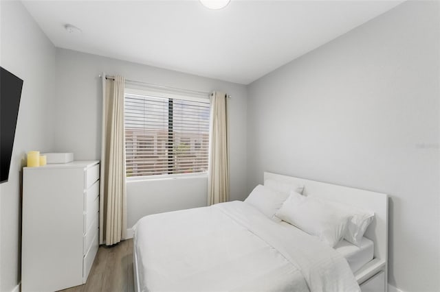 549 NE 206th Ln, Miami, FL 33179 - bedroom featuring light wood-style flooring and baseboards