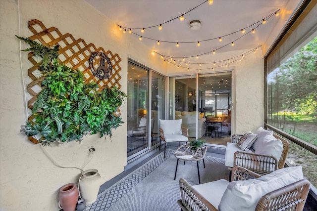 sunroom featuring an outdoor hangout area
