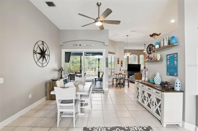 dining room with ceiling fan, baseboards, and light tile patterned flooring