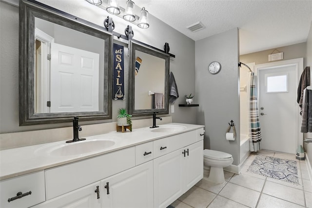 bathroom with toilet, double vanity, tile patterned floors, shower / tub combo, and a textured ceiling