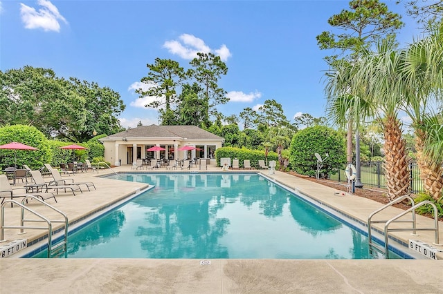 community pool featuring fence and a patio area