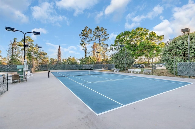 view of tennis court with fence