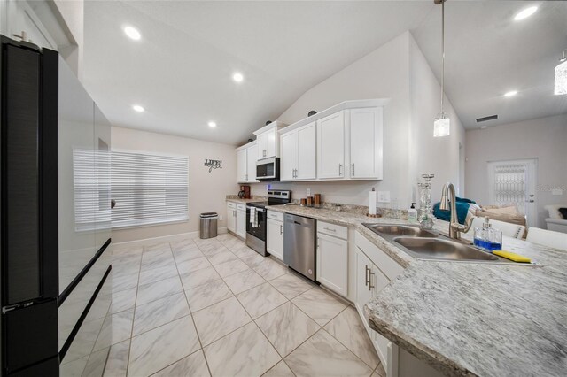 8137 Merano Ave, Fort Pierce, FL 34951 - kitchen featuring white cabinets, recessed lighting, appliances with stainless steel finishes, a sink, and lofted ceiling