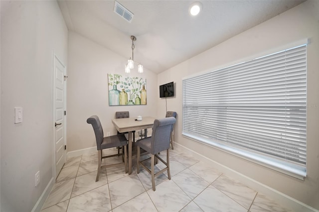 8137 Merano Ave, Fort Pierce, FL 34951 - dining area featuring visible vents, baseboards, marble finish floor, and vaulted ceiling