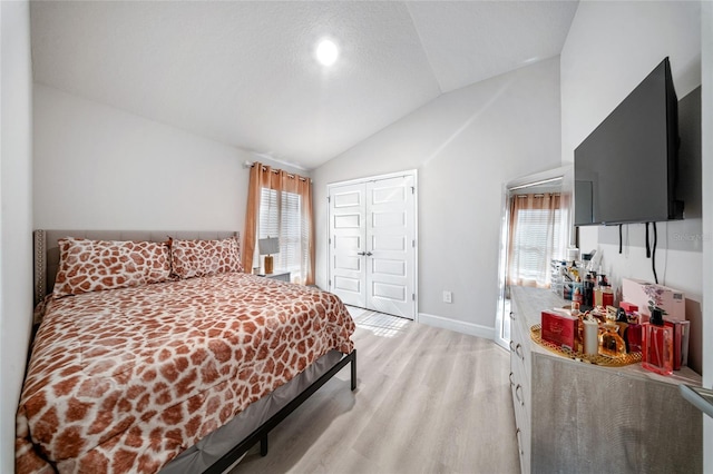 8137 Merano Ave, Fort Pierce, FL 34951 - bedroom featuring light wood-style flooring, a closet, baseboards, and lofted ceiling
