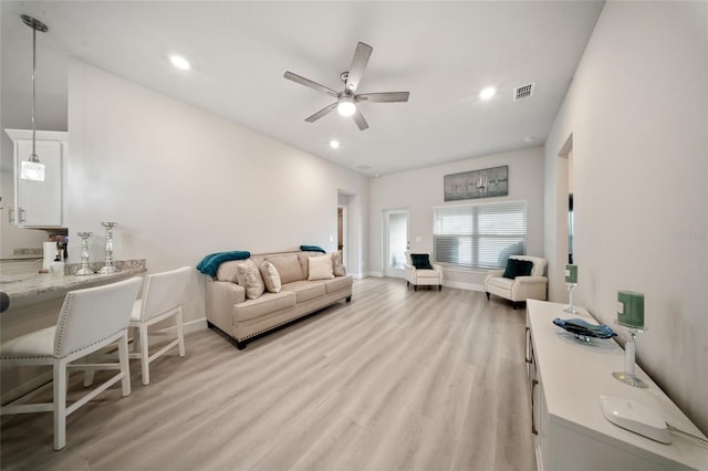 8137 Merano Ave, Fort Pierce, FL 34951 - living area featuring light wood finished floors, ceiling fan, baseboards, and visible vents