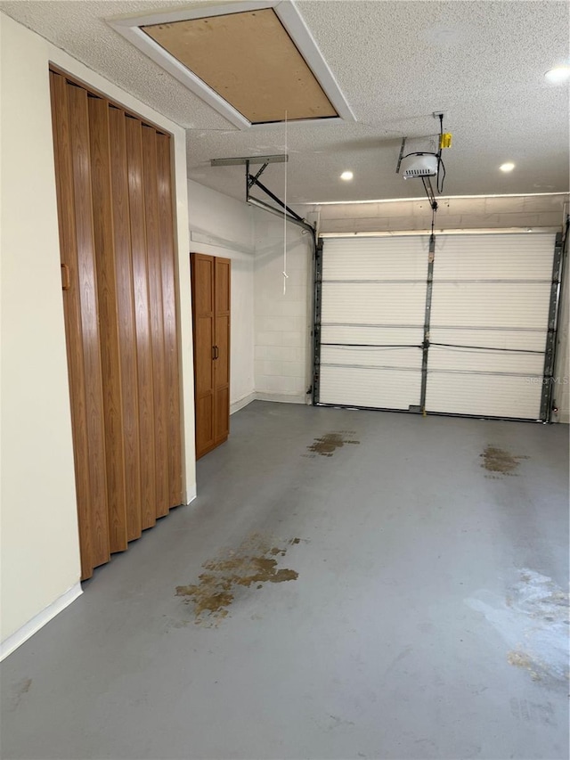 garage featuring a garage door opener and recessed lighting