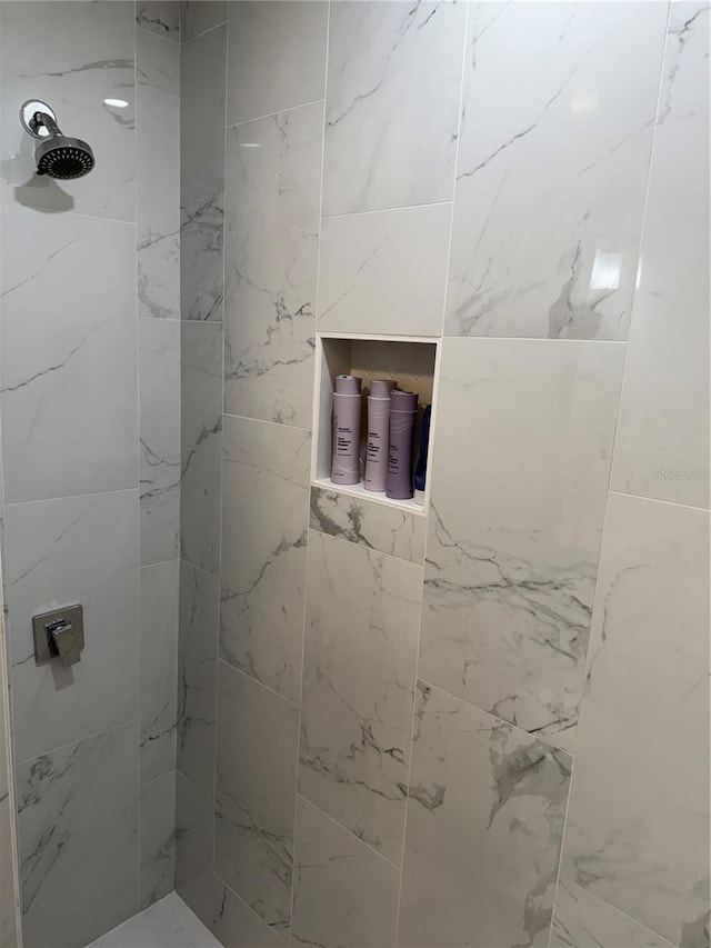 full bath with a tile shower