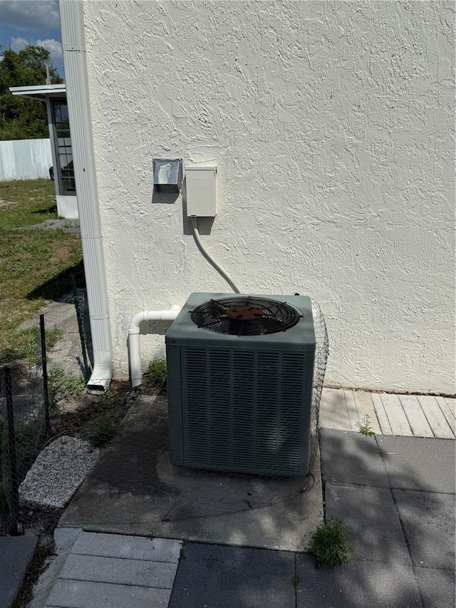 exterior details with central air condition unit and stucco siding