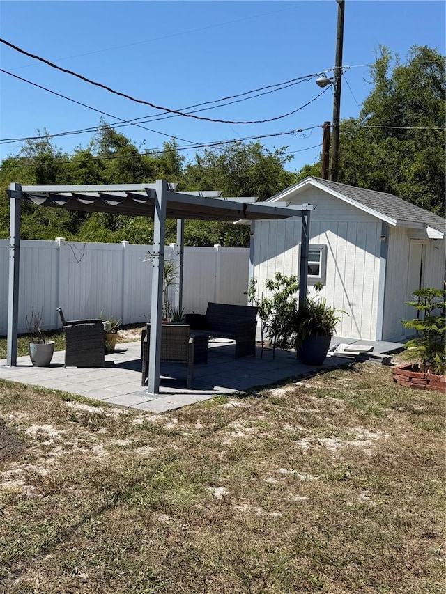 exterior space featuring a patio, an outbuilding, and fence