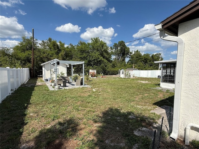 view of yard featuring a fenced backyard and an outdoor structure