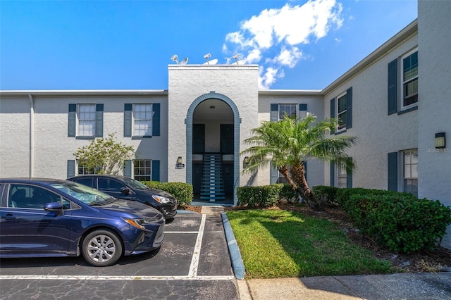 1048 Plantation Dr Unit 12, Kissimmee, FL 34741 - view of front of home featuring stucco siding and uncovered parking