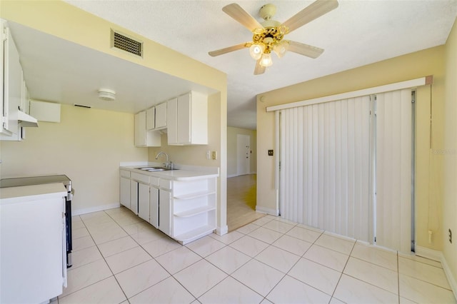 1048 Plantation Dr Unit 12, Kissimmee, FL 34741 - kitchen featuring visible vents, open shelves, a sink, light countertops, and under cabinet range hood