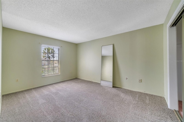 1048 Plantation Dr Unit 12, Kissimmee, FL 34741 - unfurnished bedroom featuring a closet, carpet, and a textured ceiling