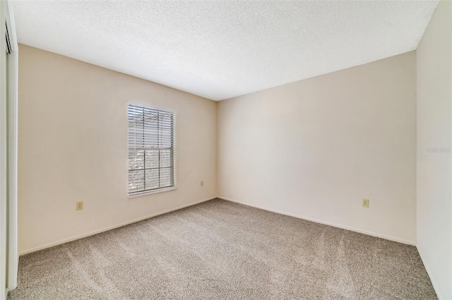 1048 Plantation Dr Unit 12, Kissimmee, FL 34741 - empty room with carpet, baseboards, and a textured ceiling