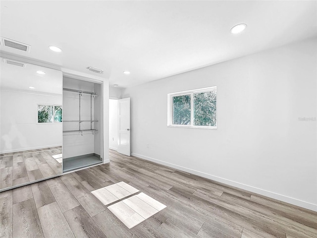 407 Sheryl Dr, Deltona, FL 32738 - unfurnished bedroom with wood finished floors, multiple windows, and recessed lighting