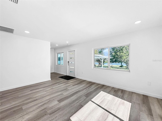 407 Sheryl Dr, Deltona, FL 32738 - unfurnished living room featuring visible vents, baseboards, wood finished floors, and recessed lighting