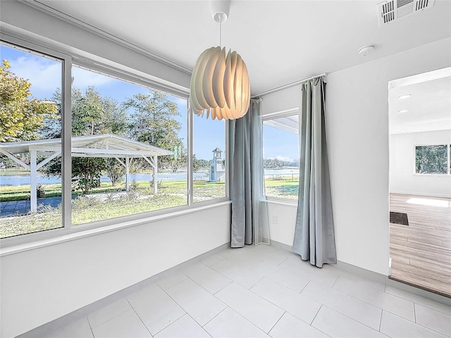 407 Sheryl Dr, Deltona, FL 32738 - unfurnished dining area with plenty of natural light, visible vents, light tile patterned floors, and a water view