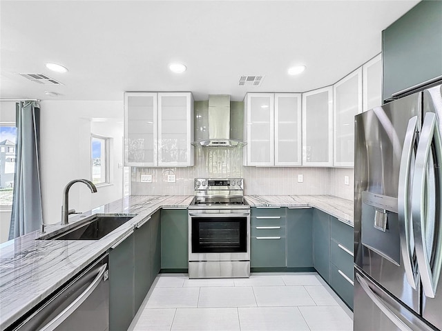407 Sheryl Dr, Deltona, FL 32738 - kitchen featuring light stone counters, stainless steel appliances, visible vents, wall chimney range hood, and a sink