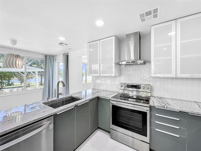 407 Sheryl Dr, Deltona, FL 32738 - kitchen with stainless steel appliances, visible vents, gray cabinets, a sink, and wall chimney exhaust hood