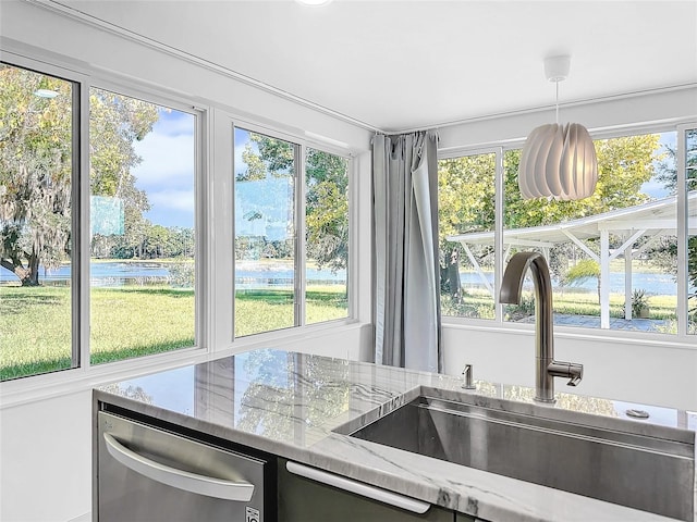407 Sheryl Dr, Deltona, FL 32738 - kitchen featuring stainless steel dishwasher, light stone countertops, a sink, and a water view